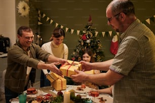 a group of people standing around a table with presents