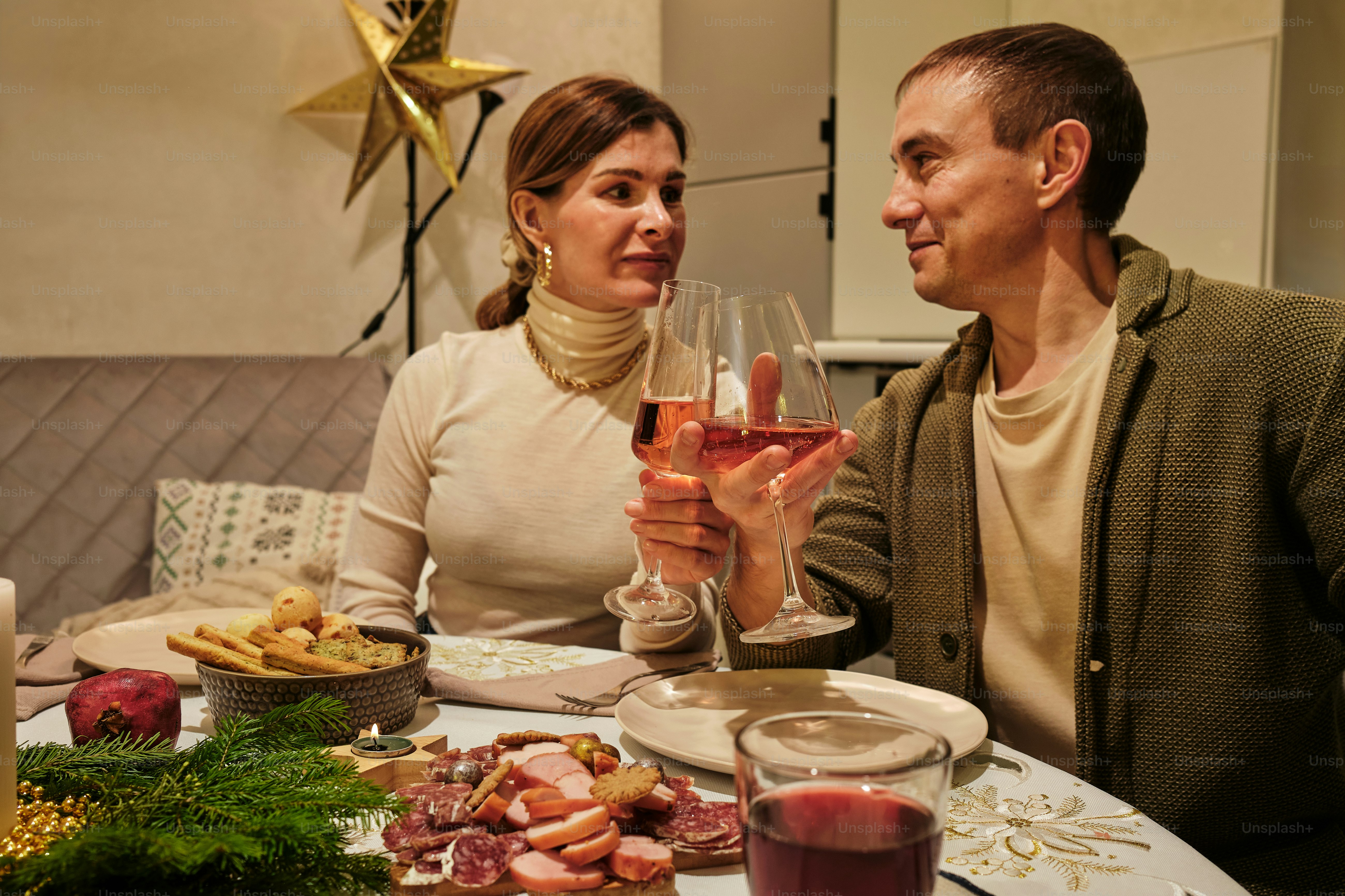 a man and a woman sitting at a table with a glass of wine