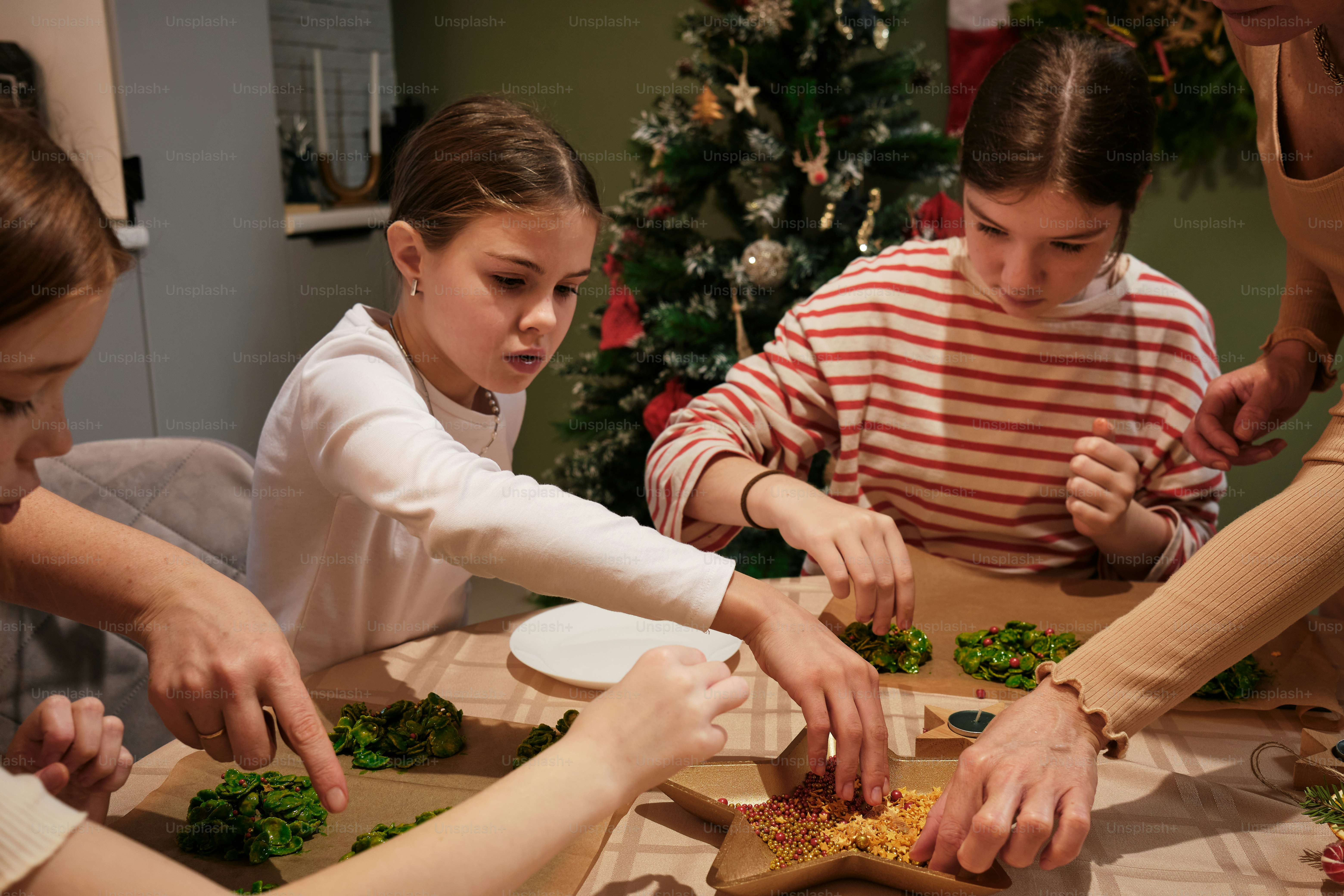 A group of people standing around a table preparing food photo ...