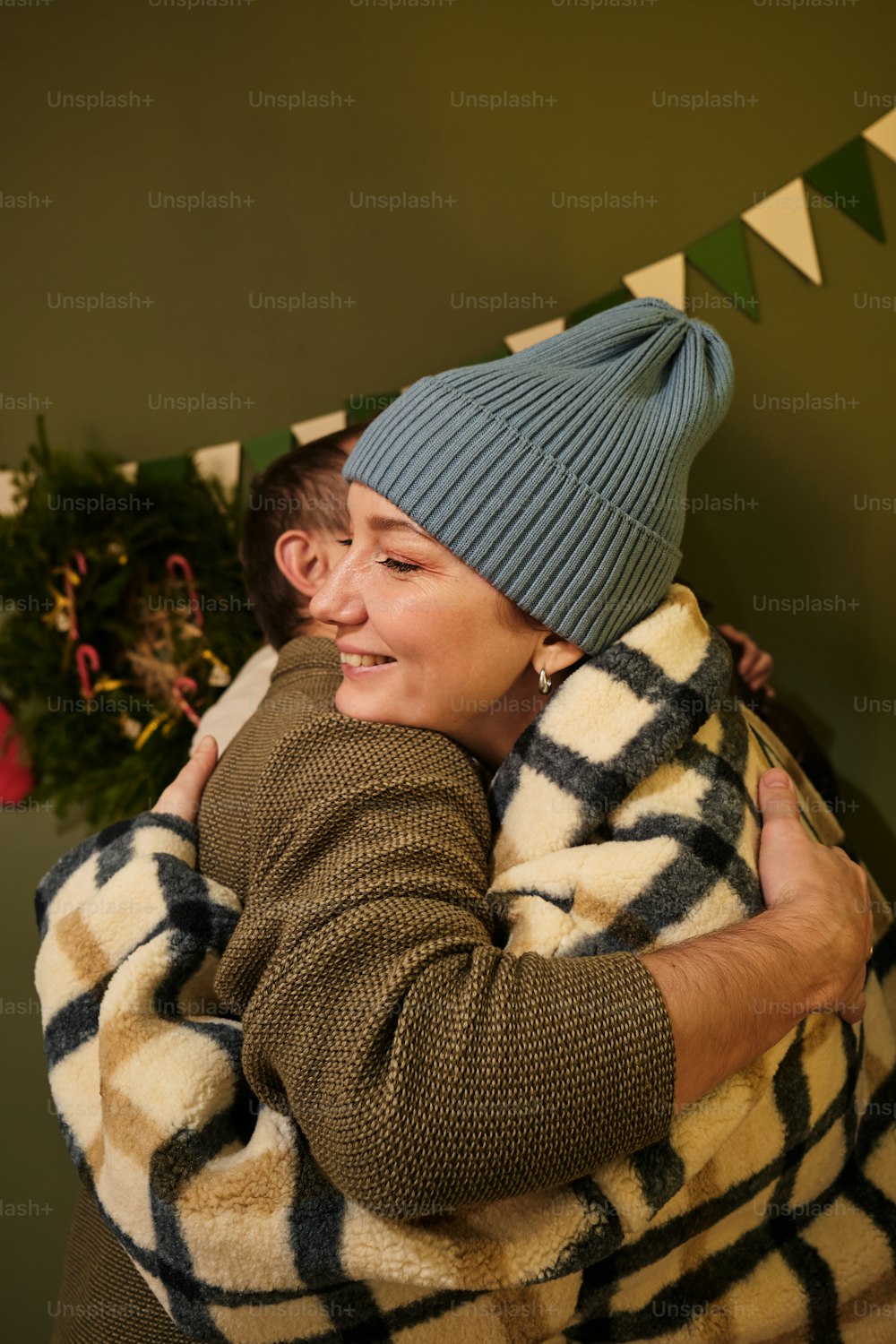 a woman wrapped in a blanket hugging a man