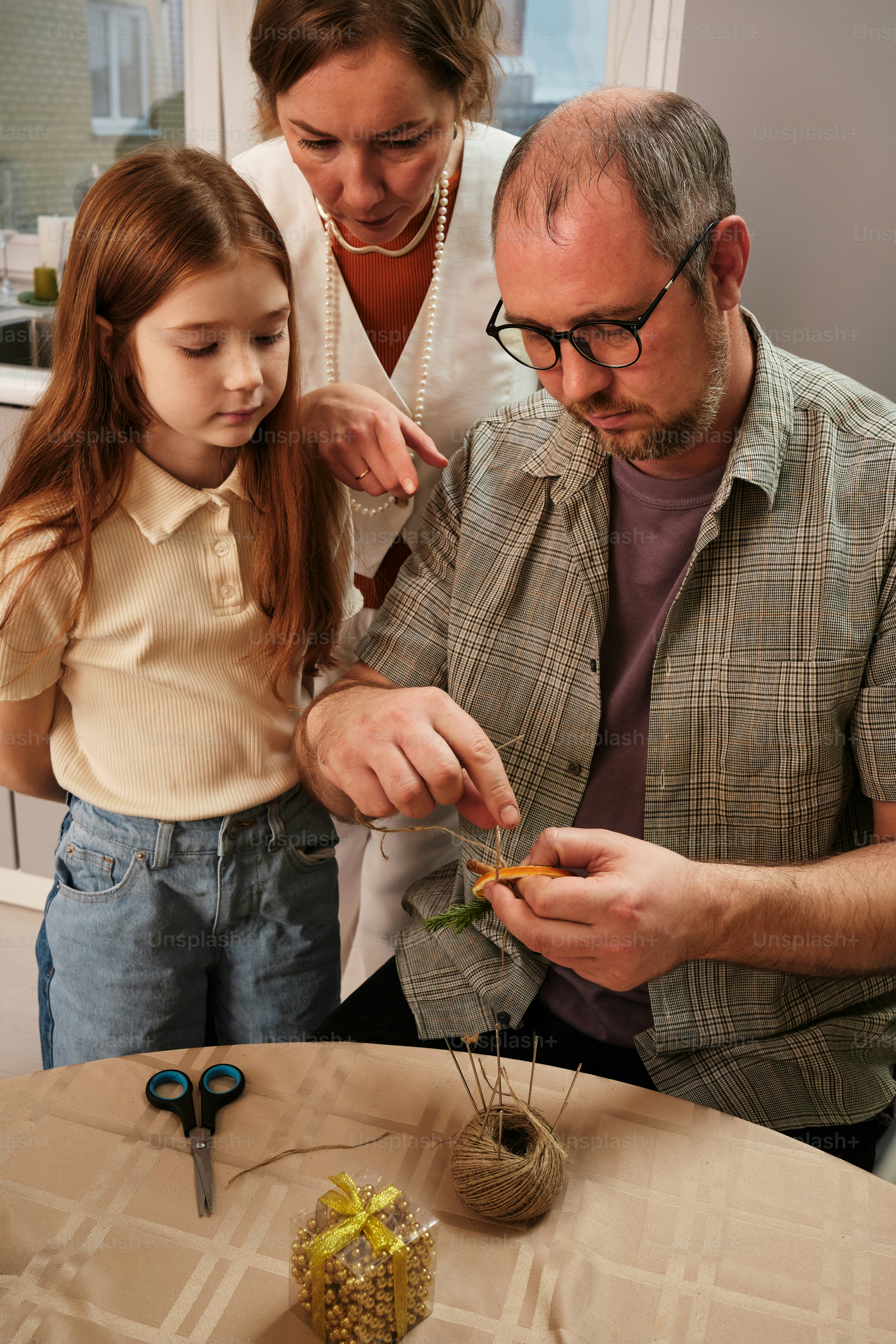 a man and a little girl are looking at a piece of food