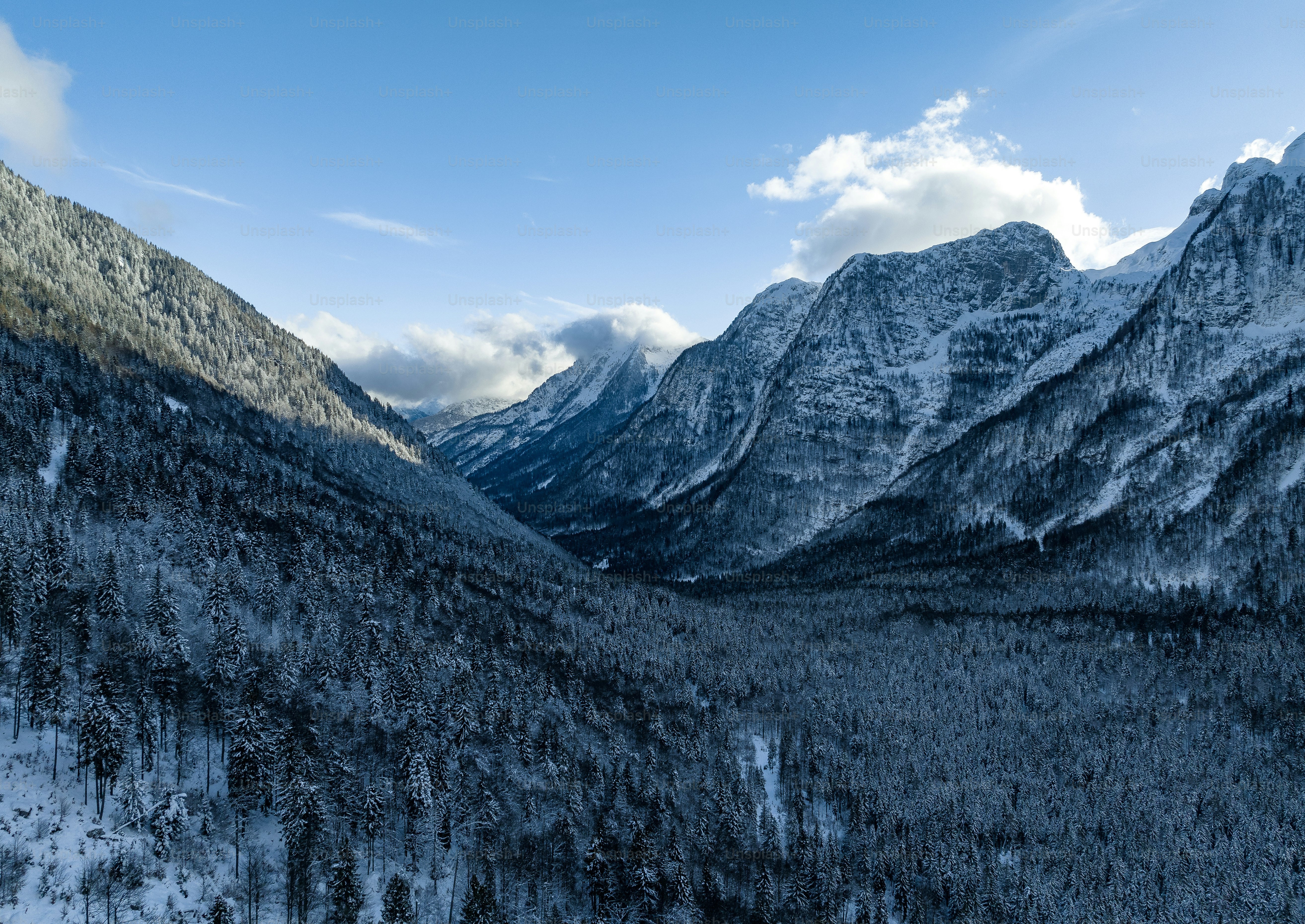 a view of a mountain range with snow on the ground