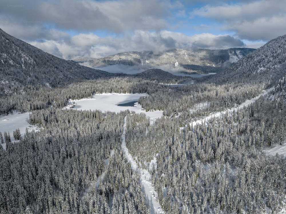 a view of a snow covered mountain with a lake in the middle