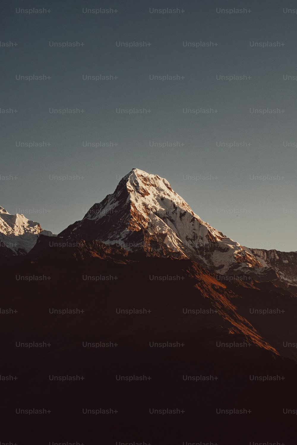 a snow covered mountain with a sky background