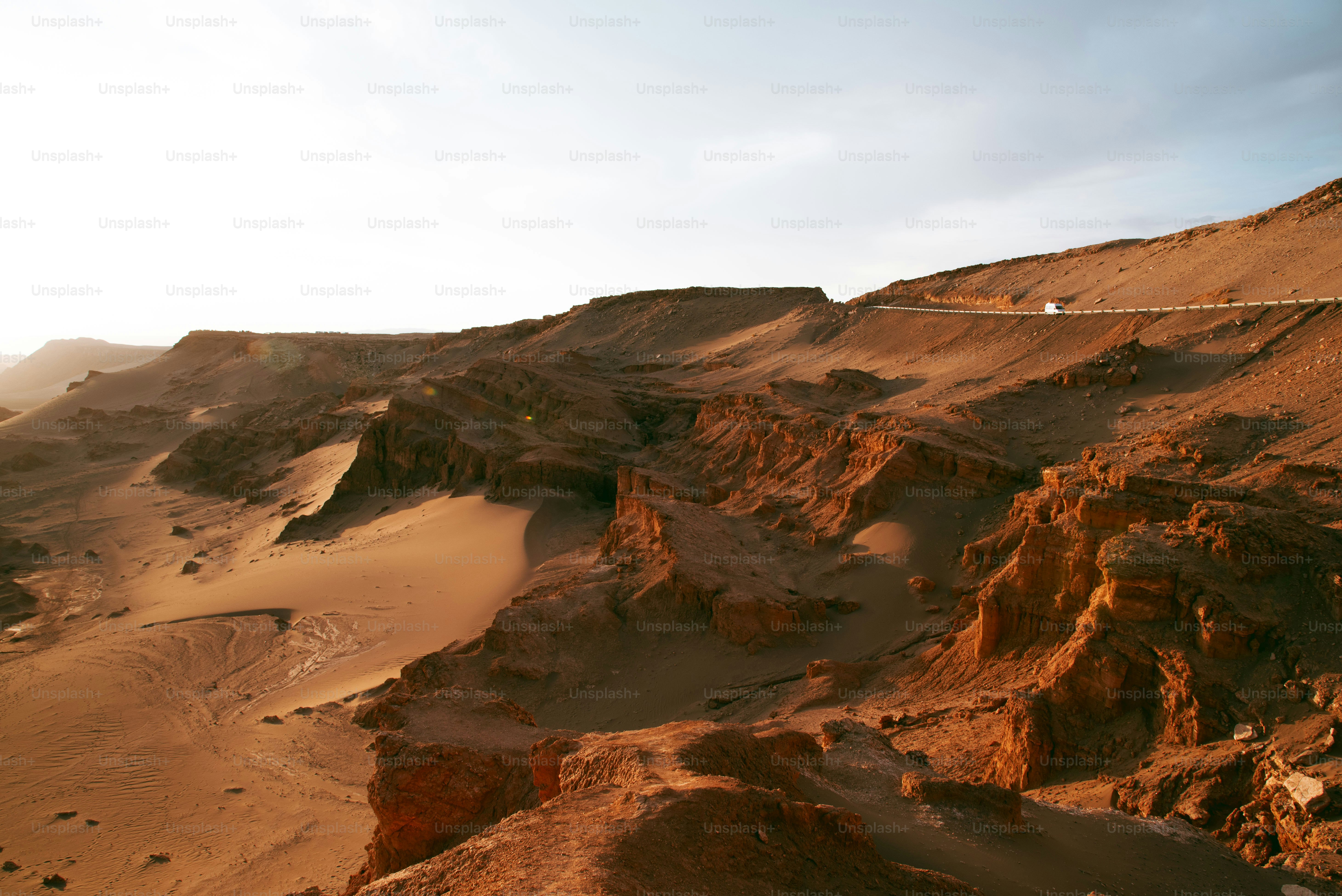 a desert landscape with a road going through it