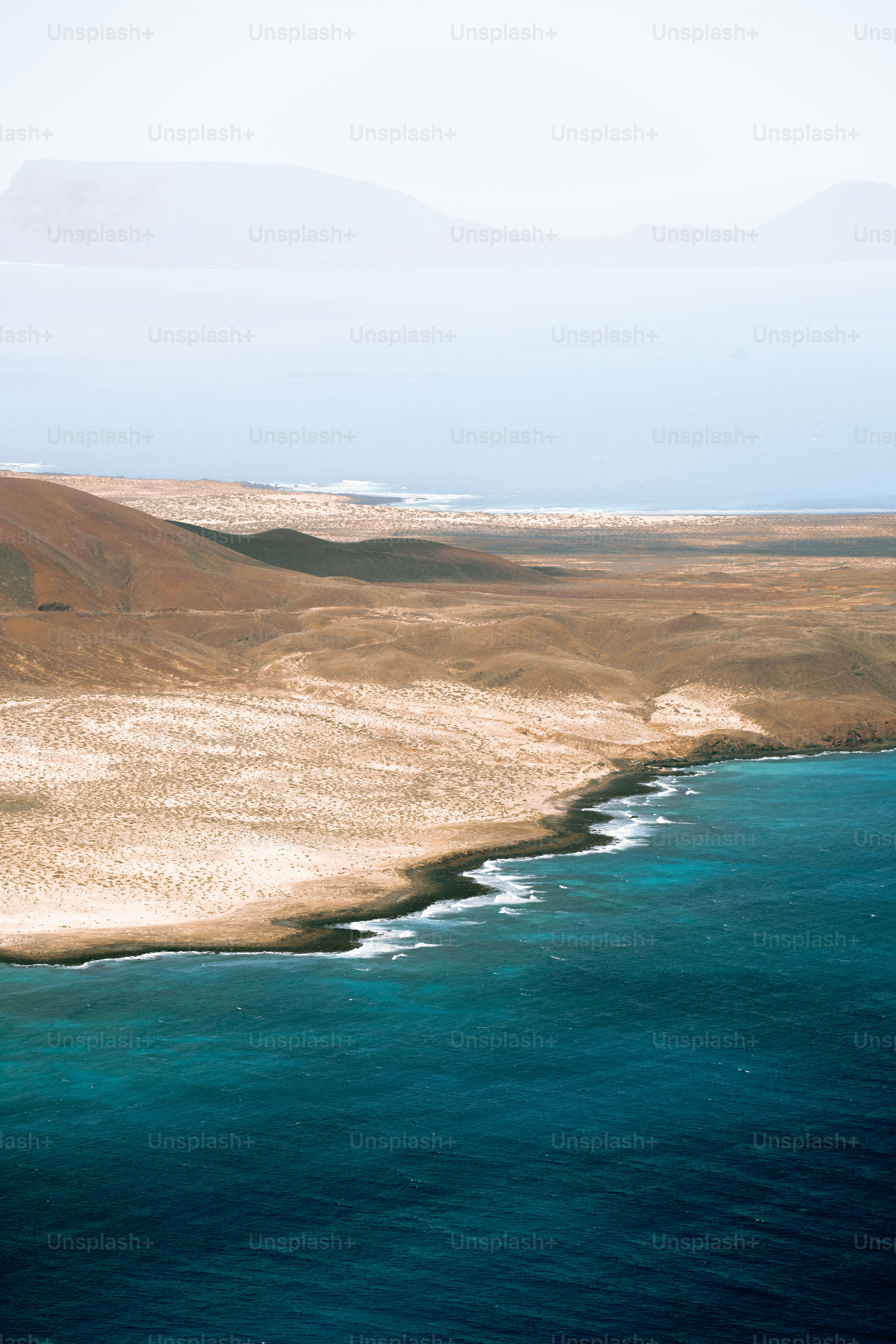 a large body of water sitting next to a sandy beach
