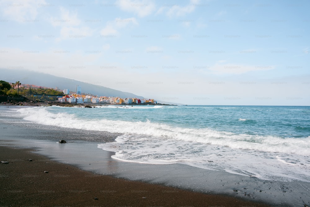 a beach with waves coming in to shore