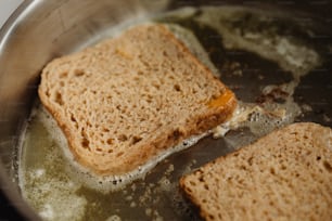two pieces of bread are being cooked in a pan