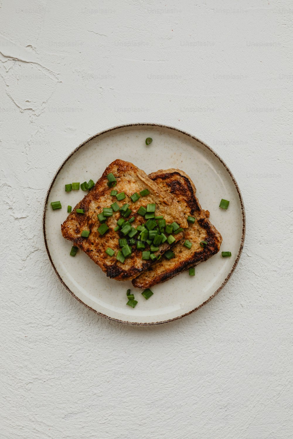 a white plate topped with two pieces of toast