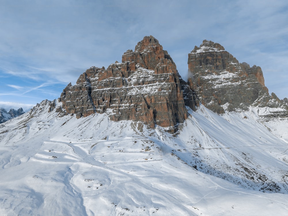 a snow covered mountain with a ski lift in the foreground