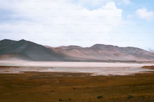 a landscape with mountains and a body of water