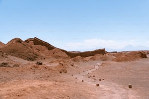 a dirt field with a mountain in the background