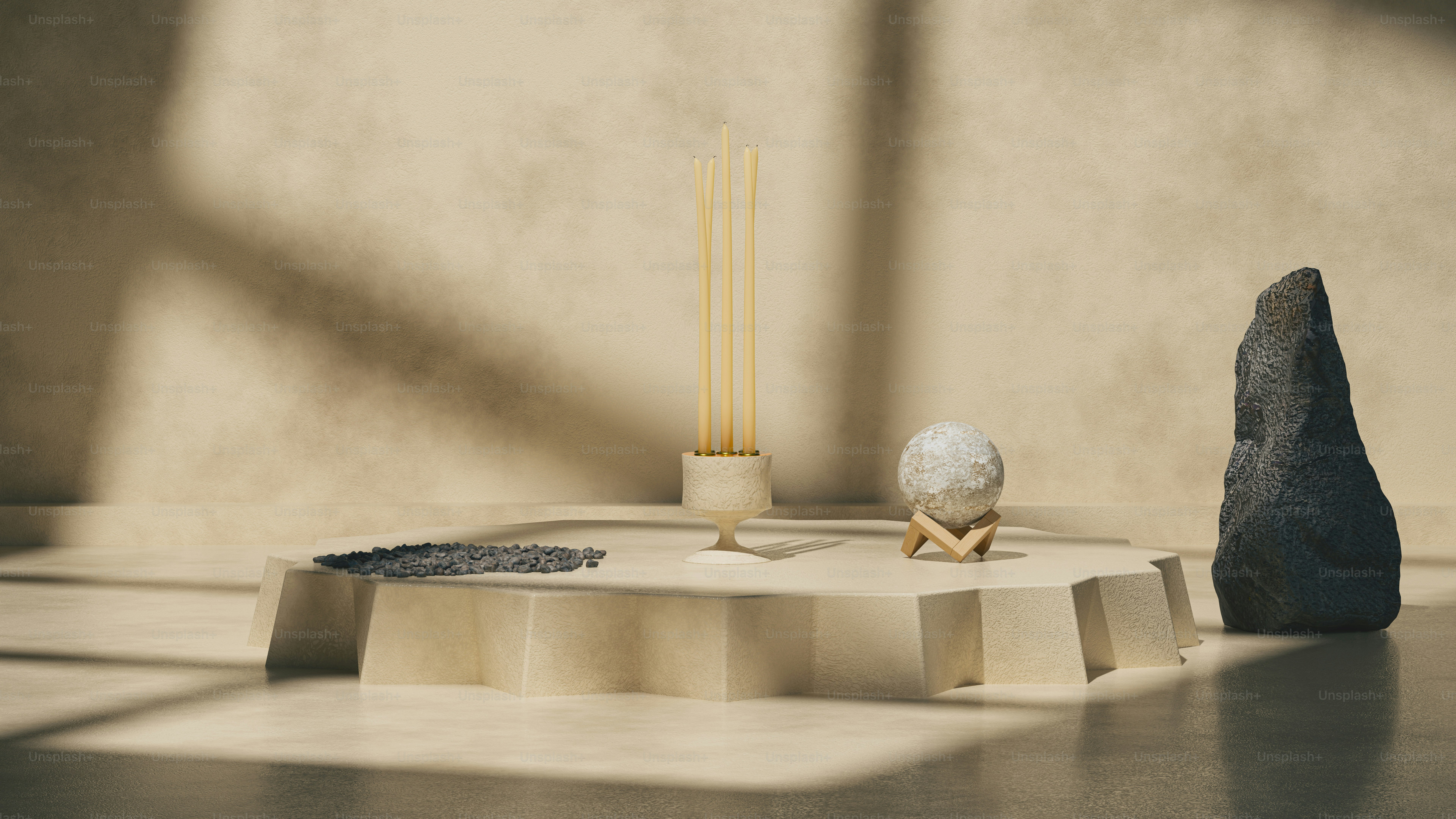 a table with a rock and two candles on it