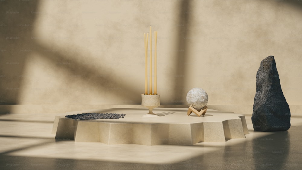 a table with a rock and two candles on it