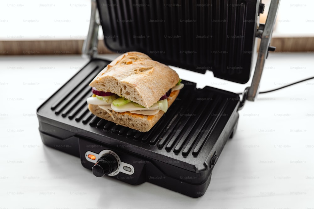 a sandwich sitting on top of a black grill