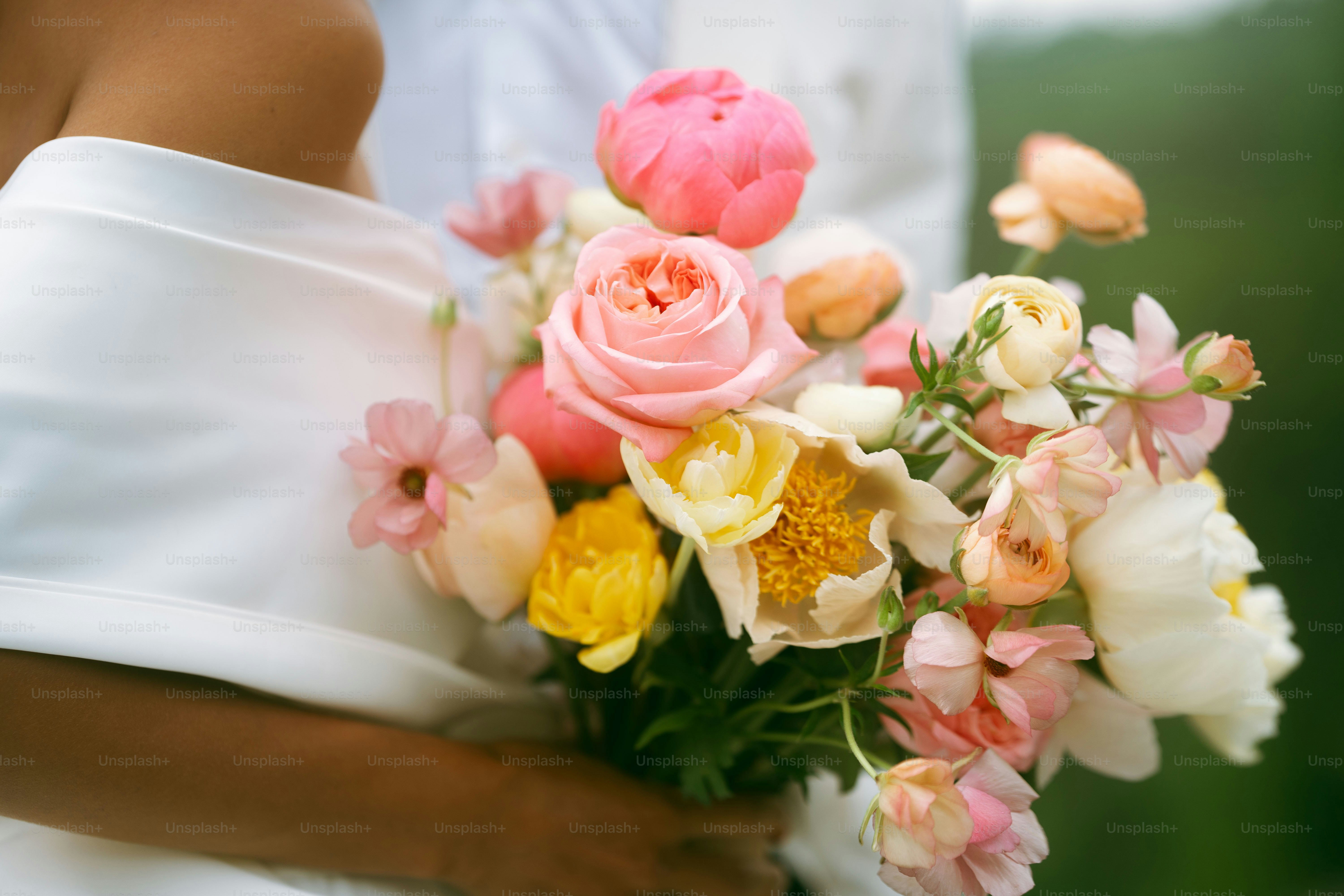 a bride holding a bouquet of flowers in her hands