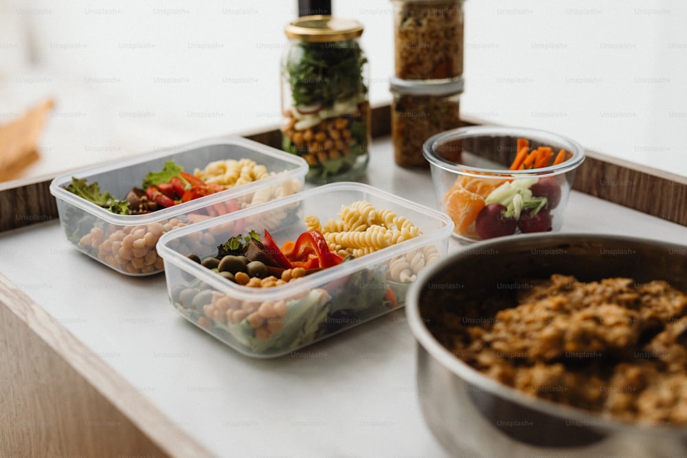 a variety of food in plastic containers on a counter