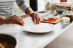 a person cutting up a piece of paper on top of a counter