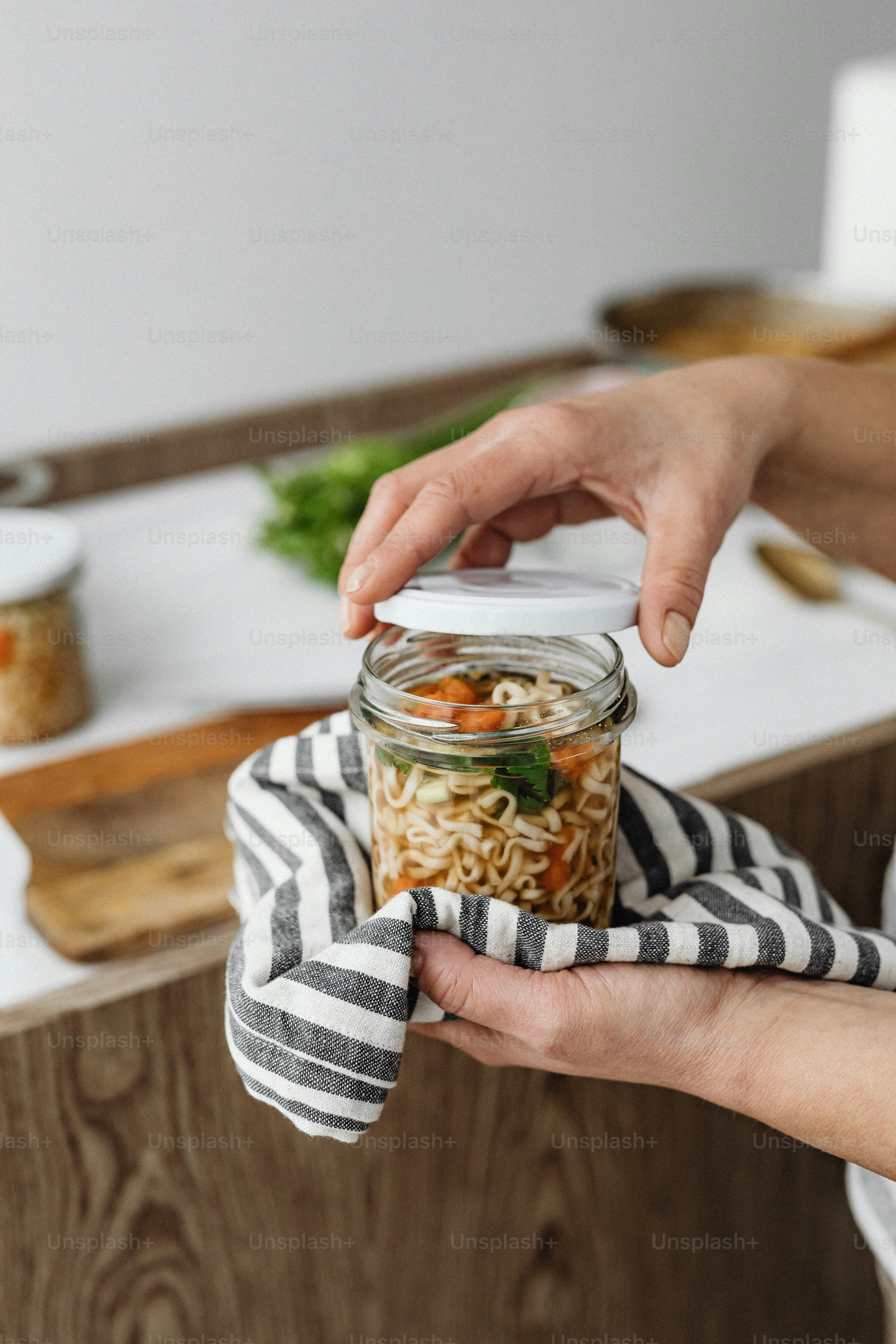 a person holding a jar of food in their hand