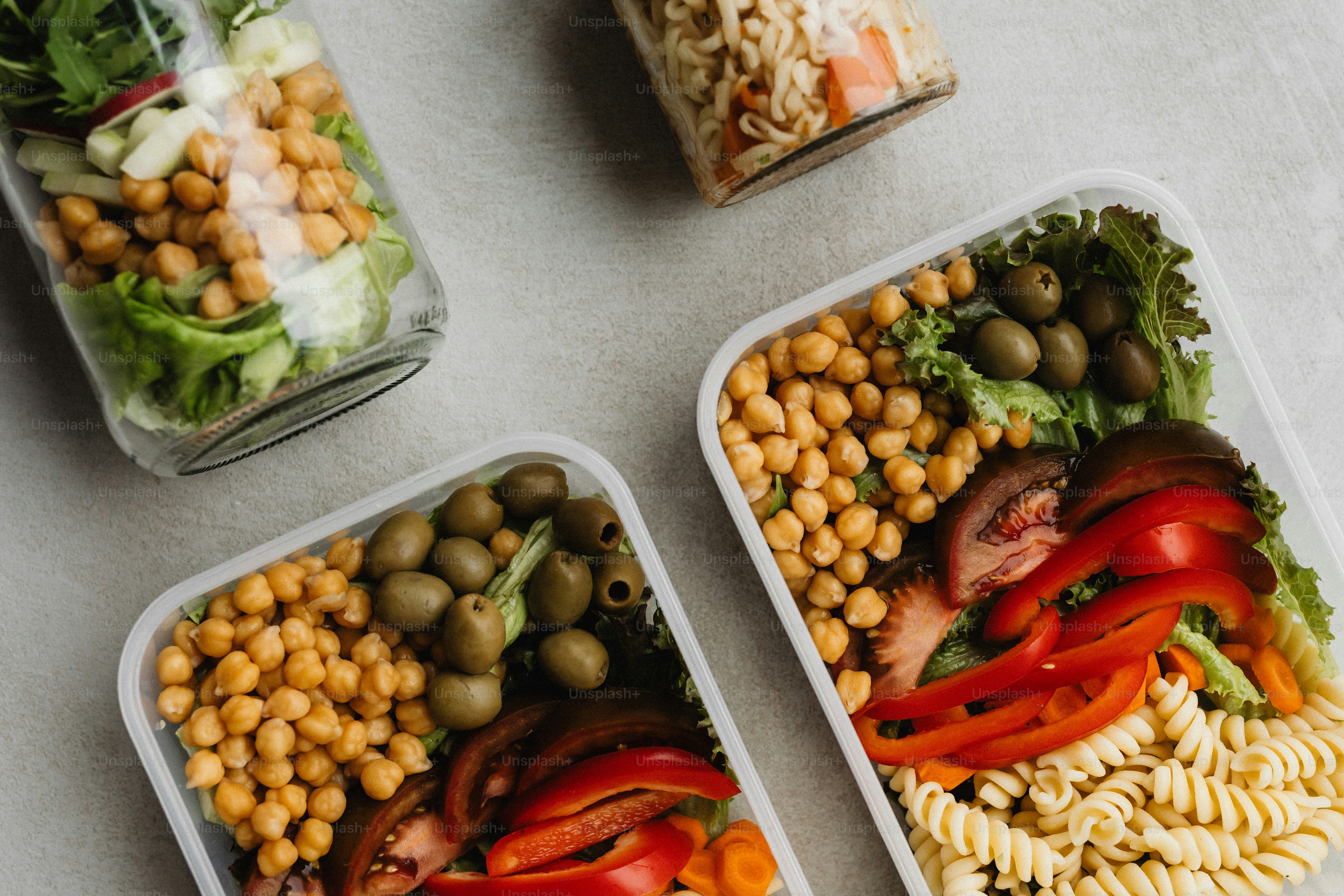 a couple of containers filled with food on top of a table