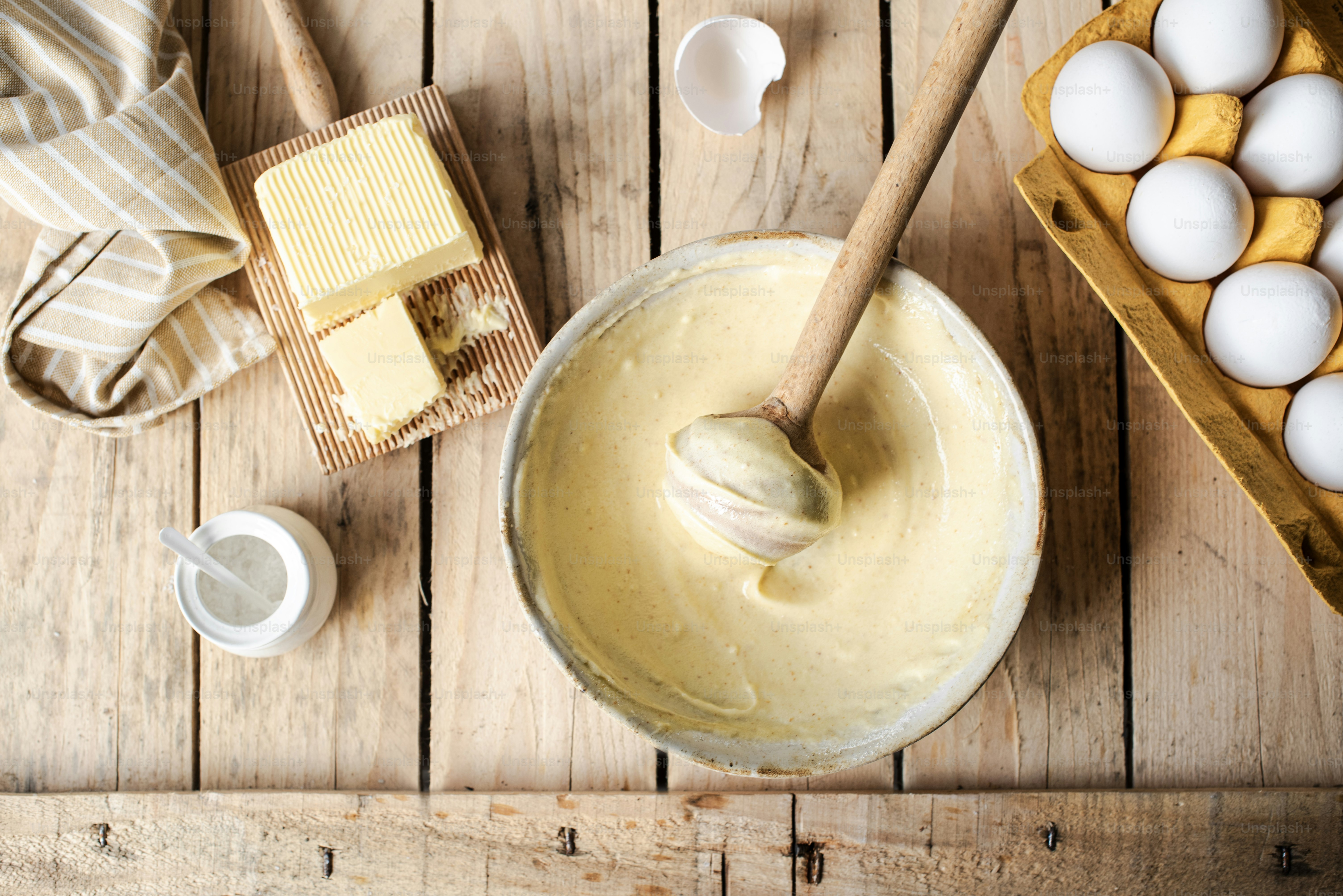 Whipped brown butter for a cake in a bowl on a wooden table