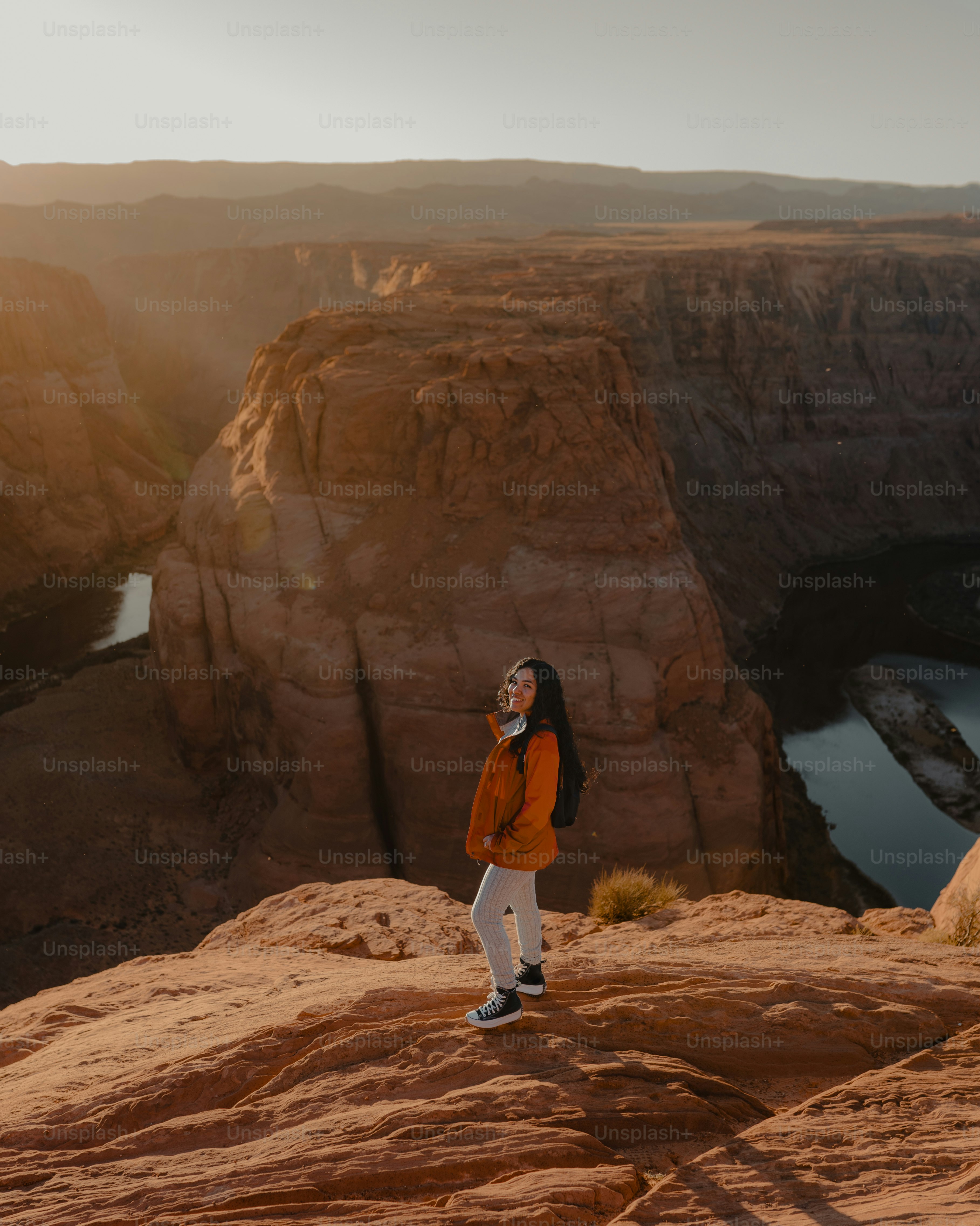 A woman standing on top of a rocky cliff photo – Arizona Image on Unsplash