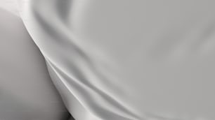 a close up of a bed with a white sheet