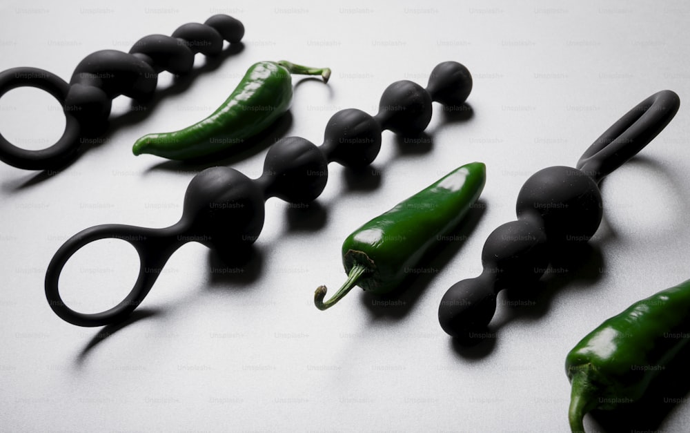 a group of black and green pepper shaped objects