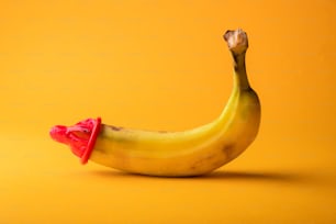 a banana with a red bow on it