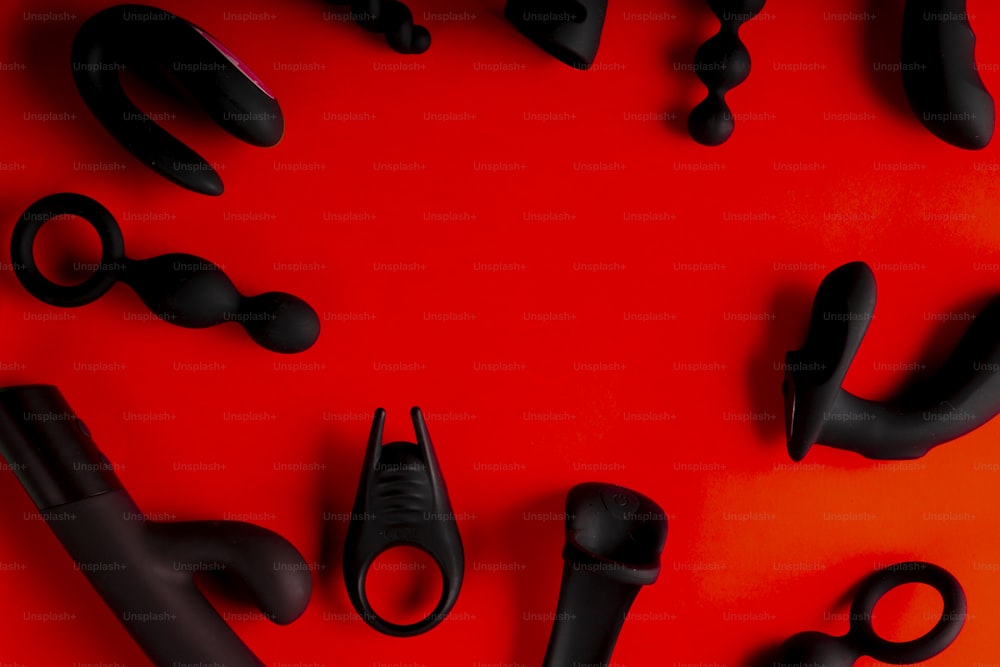 a group of black objects on a red surface