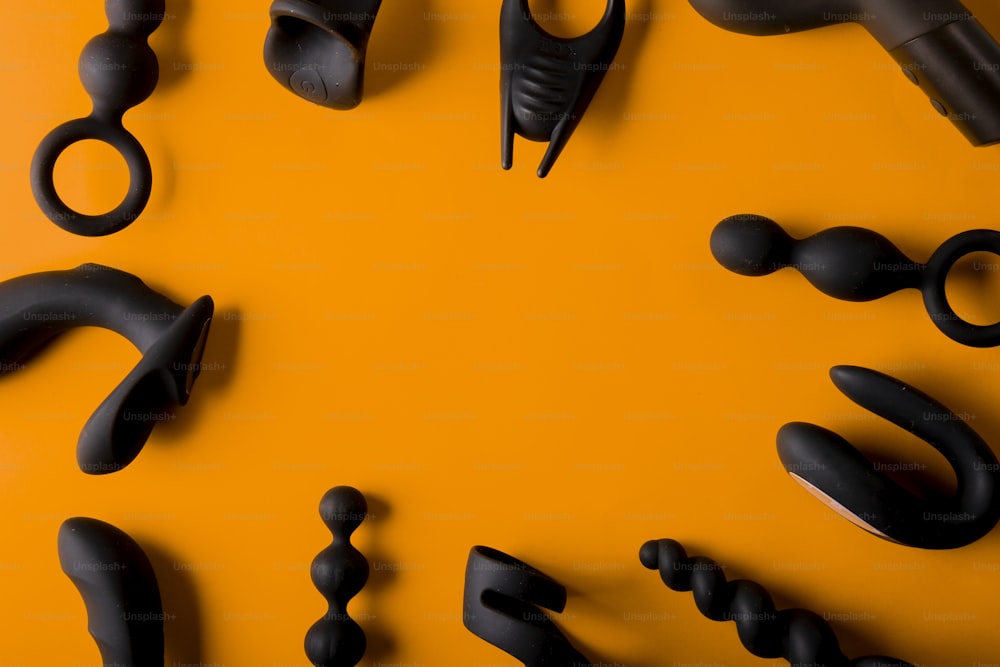 a group of black objects on an orange background