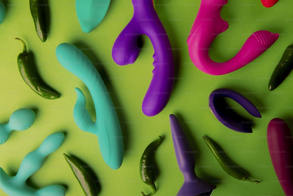a group of different colored objects on a green surface