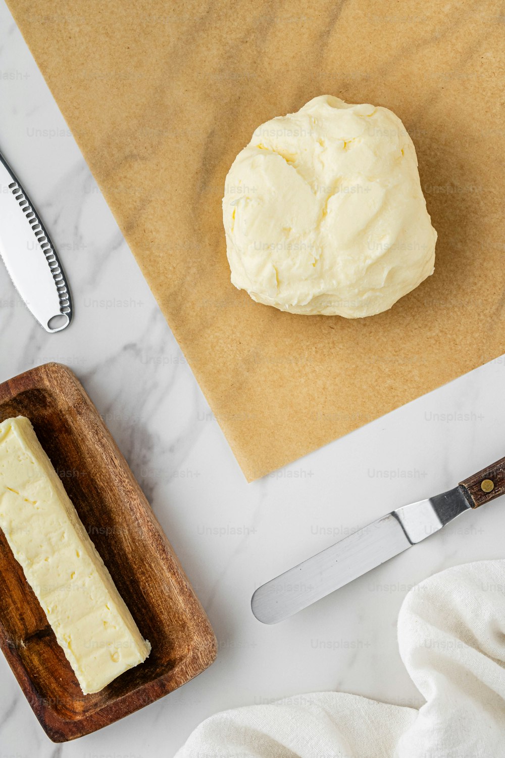 a piece of cheese sitting on top of a cutting board next to a knife