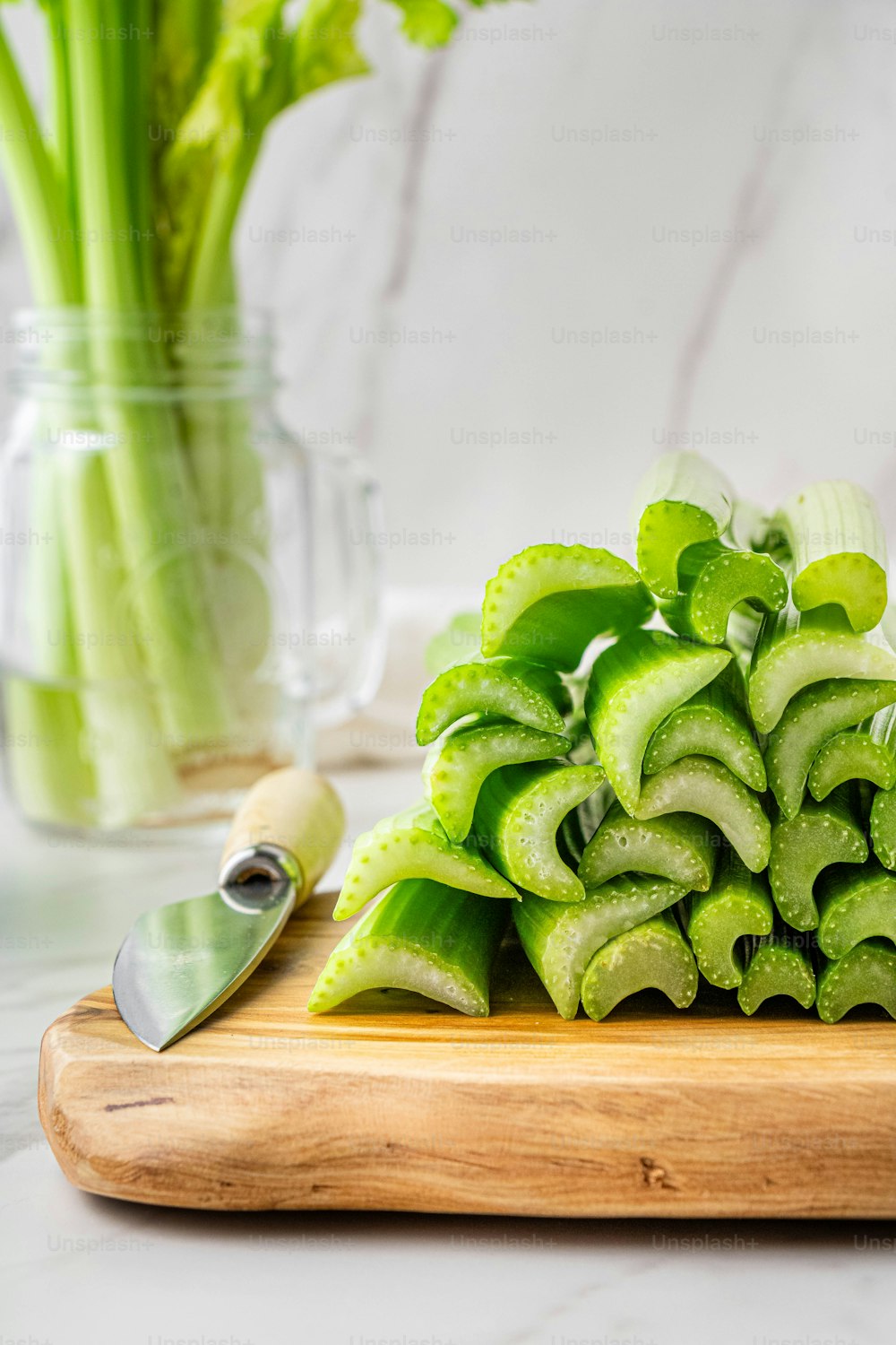 a pile of sliced green vegetables on a cutting board
