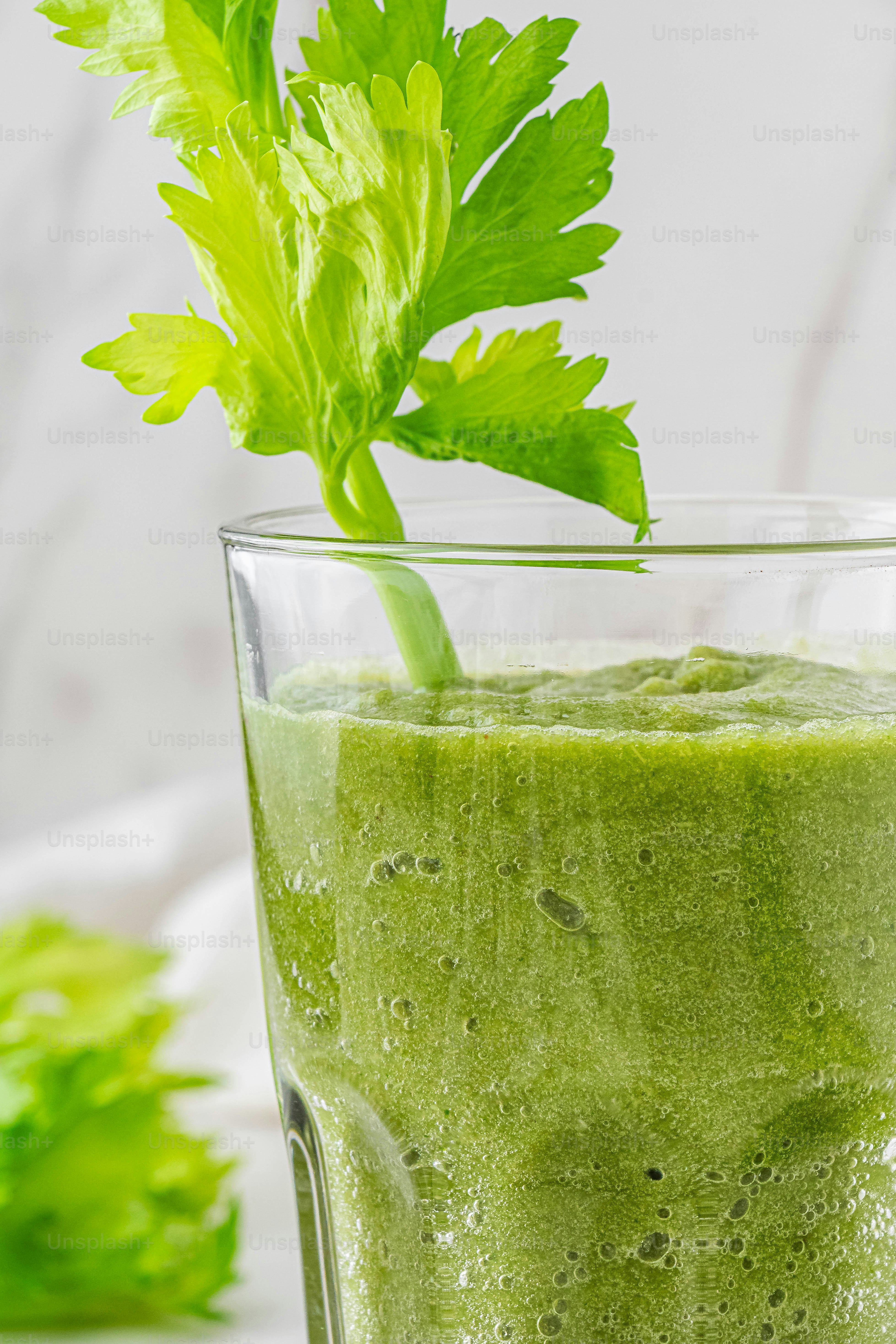 a green drink with a leaf sticking out of it