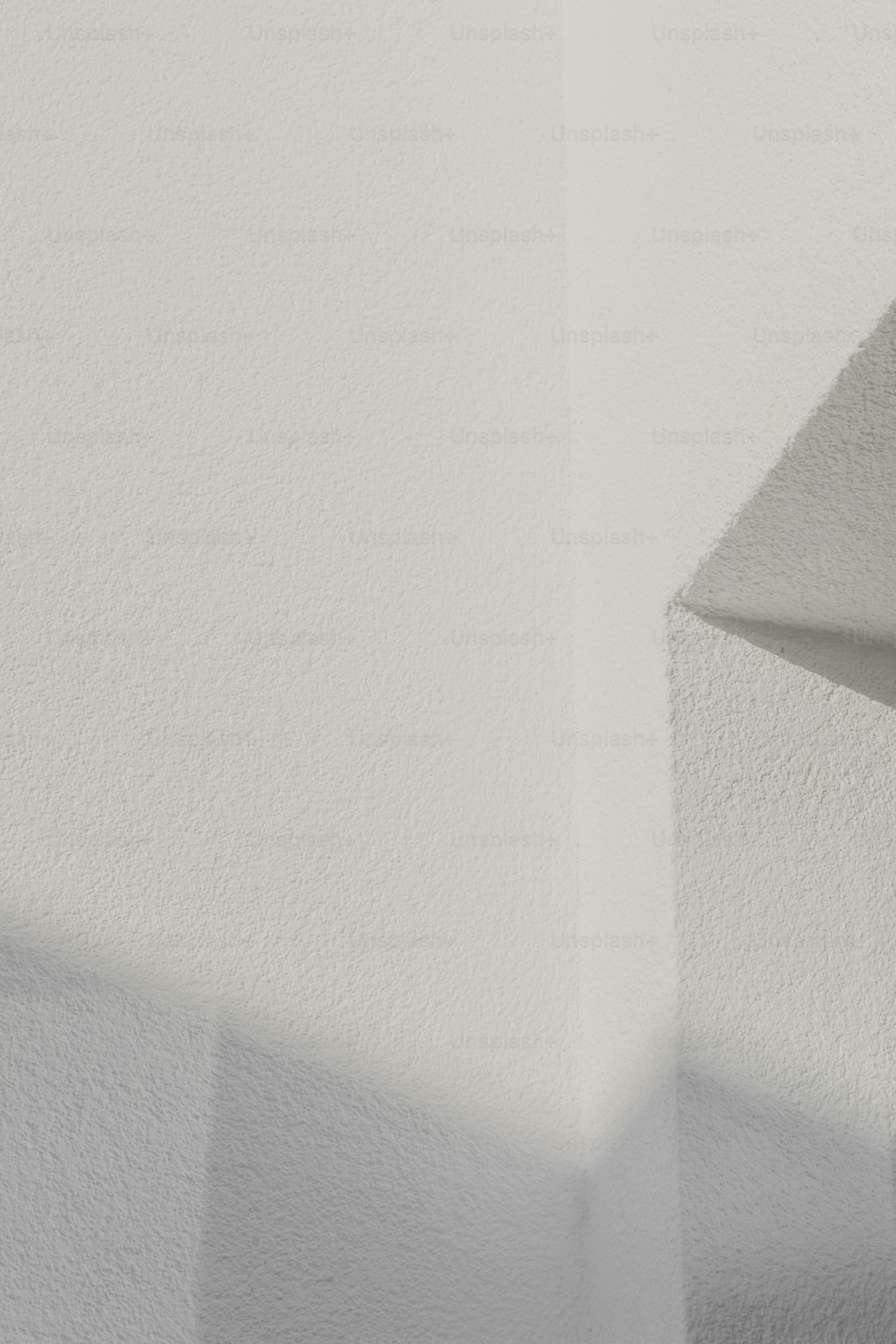 a black and white photo of a corner of a wall