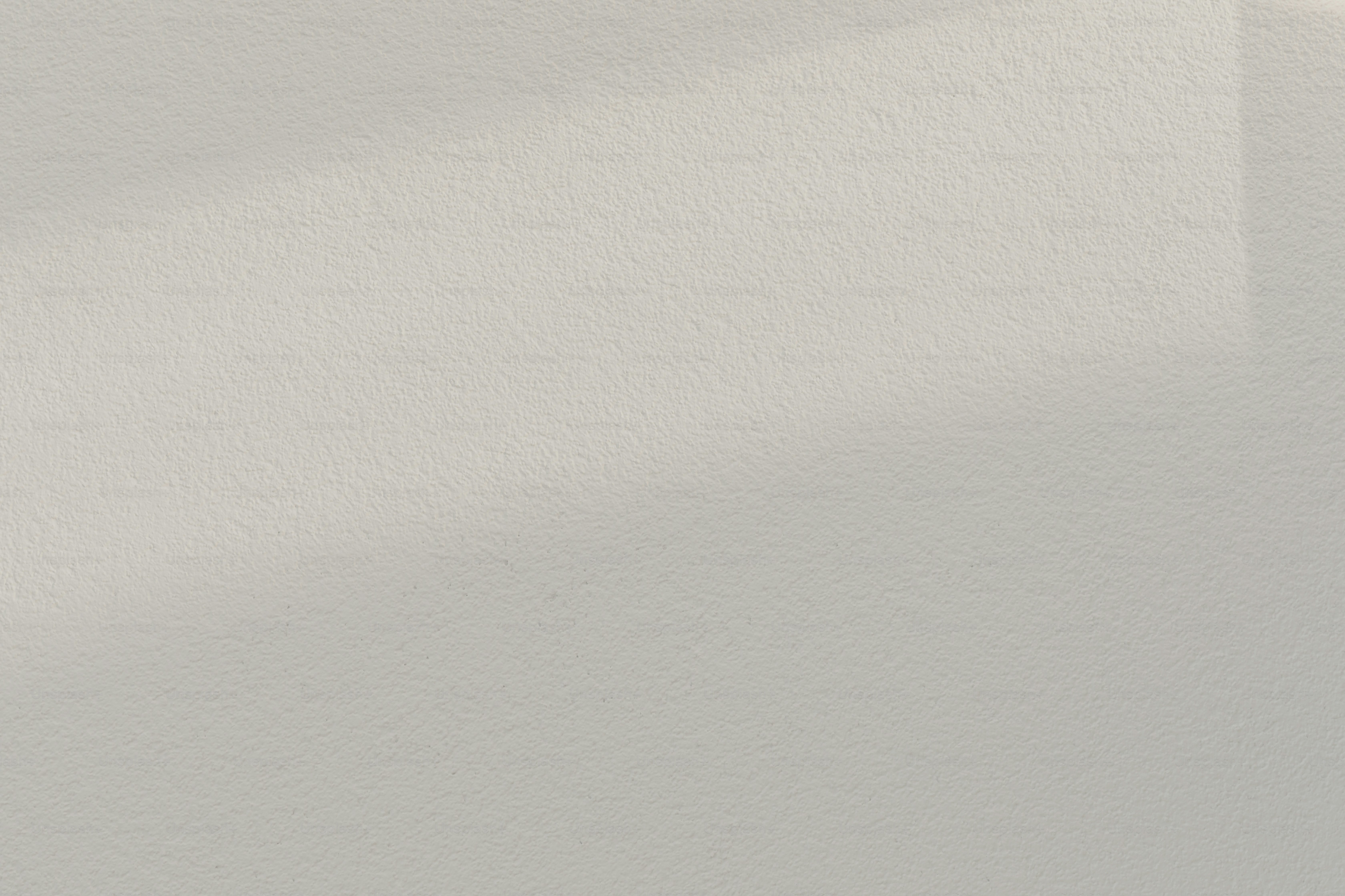 a black and white photo of a white wall