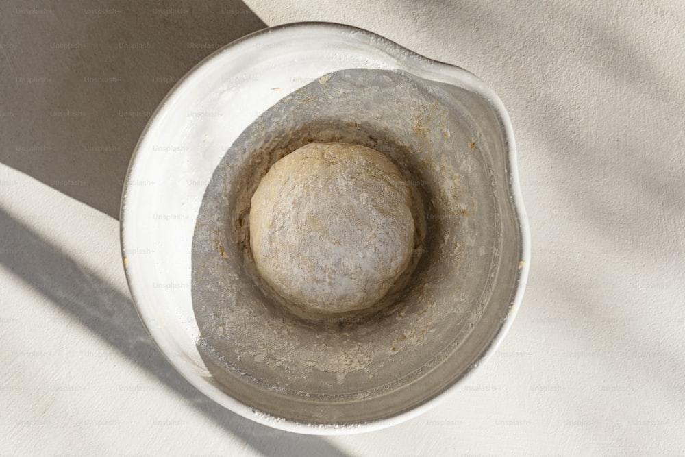 a bowl with a ball of dough inside of it