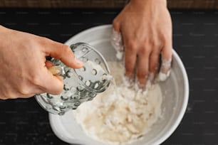 a person is mixing something in a bowl