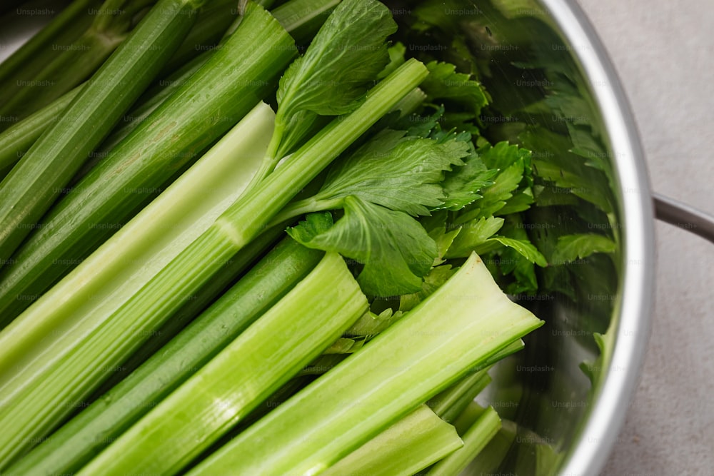 a bunch of celery is in a pot