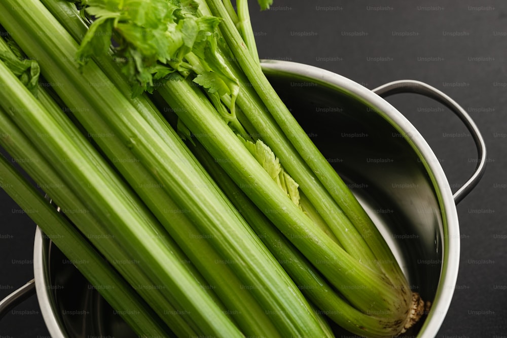 a bunch of celery sitting in a pot on a table