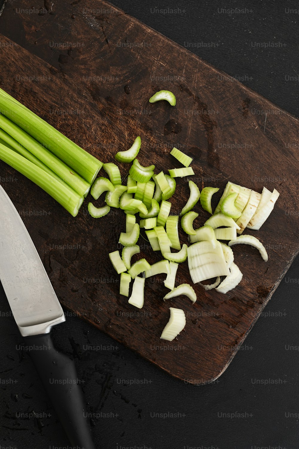 a cutting board with celery and a knife on it
