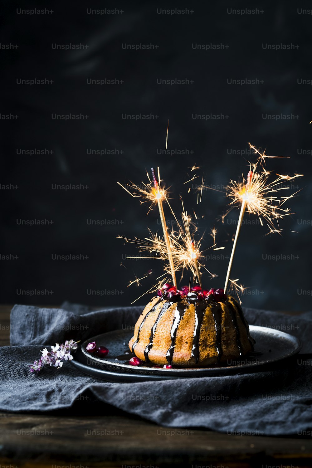 a bundt cake with sparklers on a plate