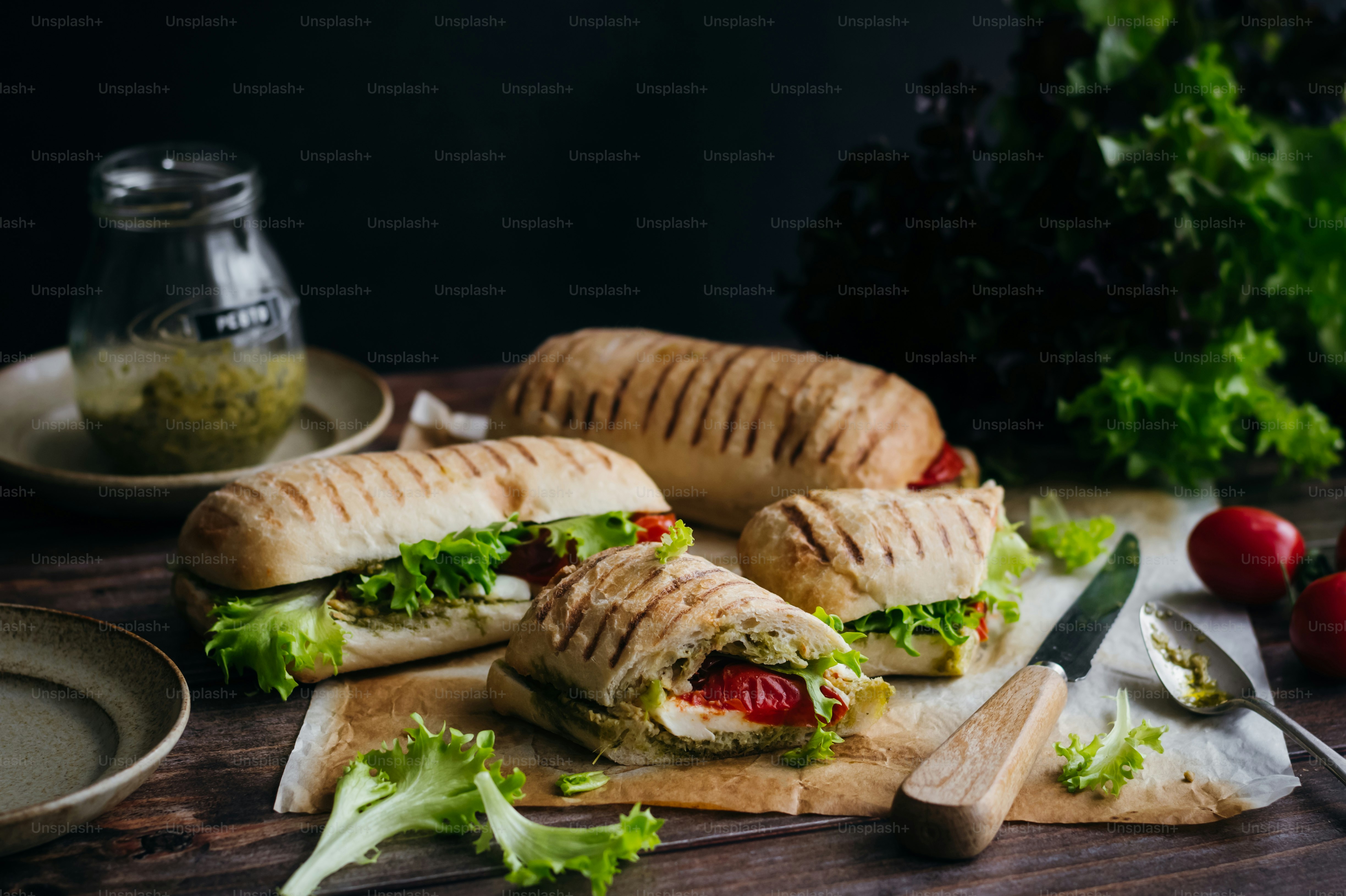 a couple of sandwiches sitting on top of a cutting board