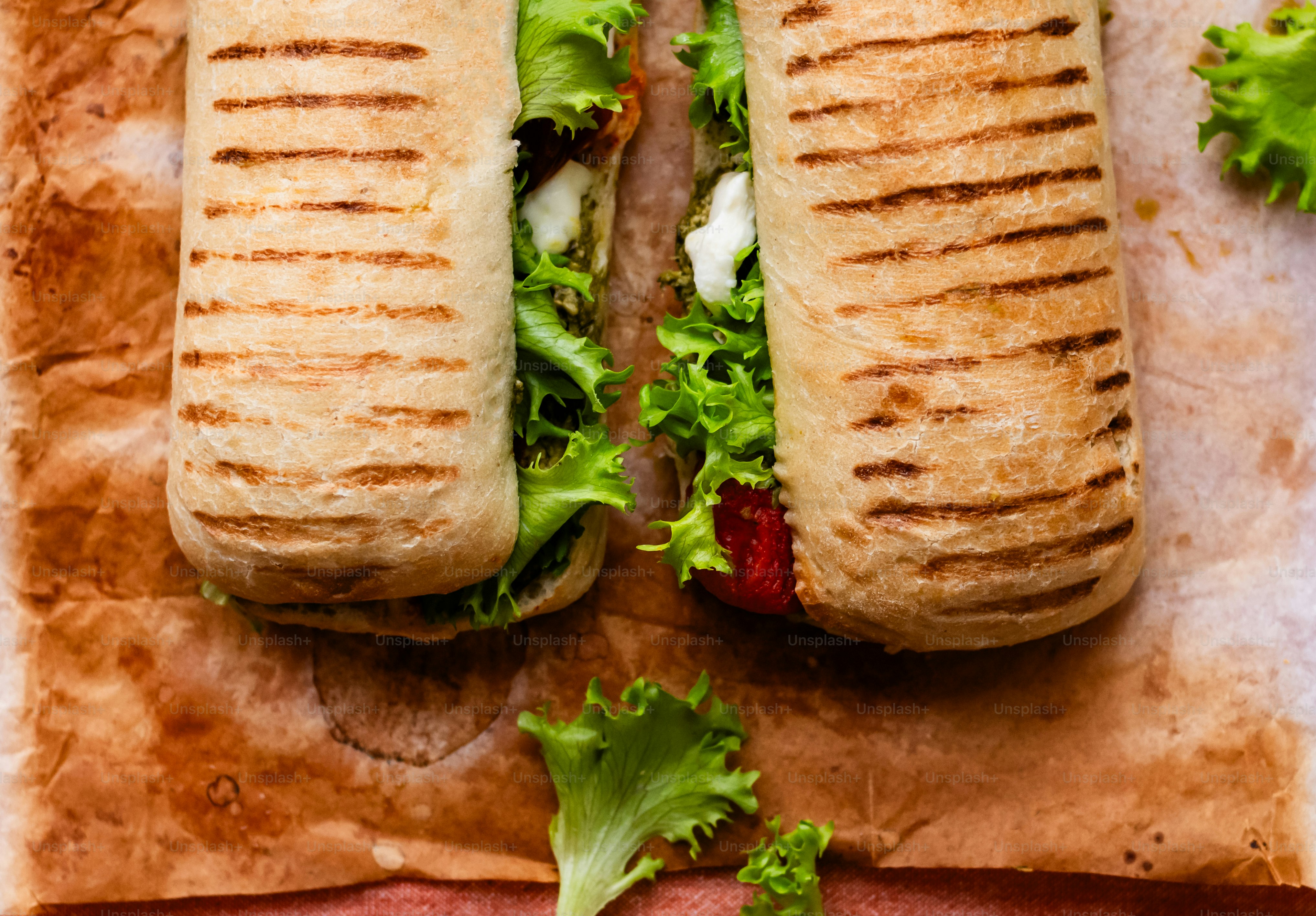 a couple of sandwiches sitting on top of a piece of paper