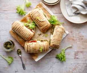 a sandwich cut in half with lettuce and tomato