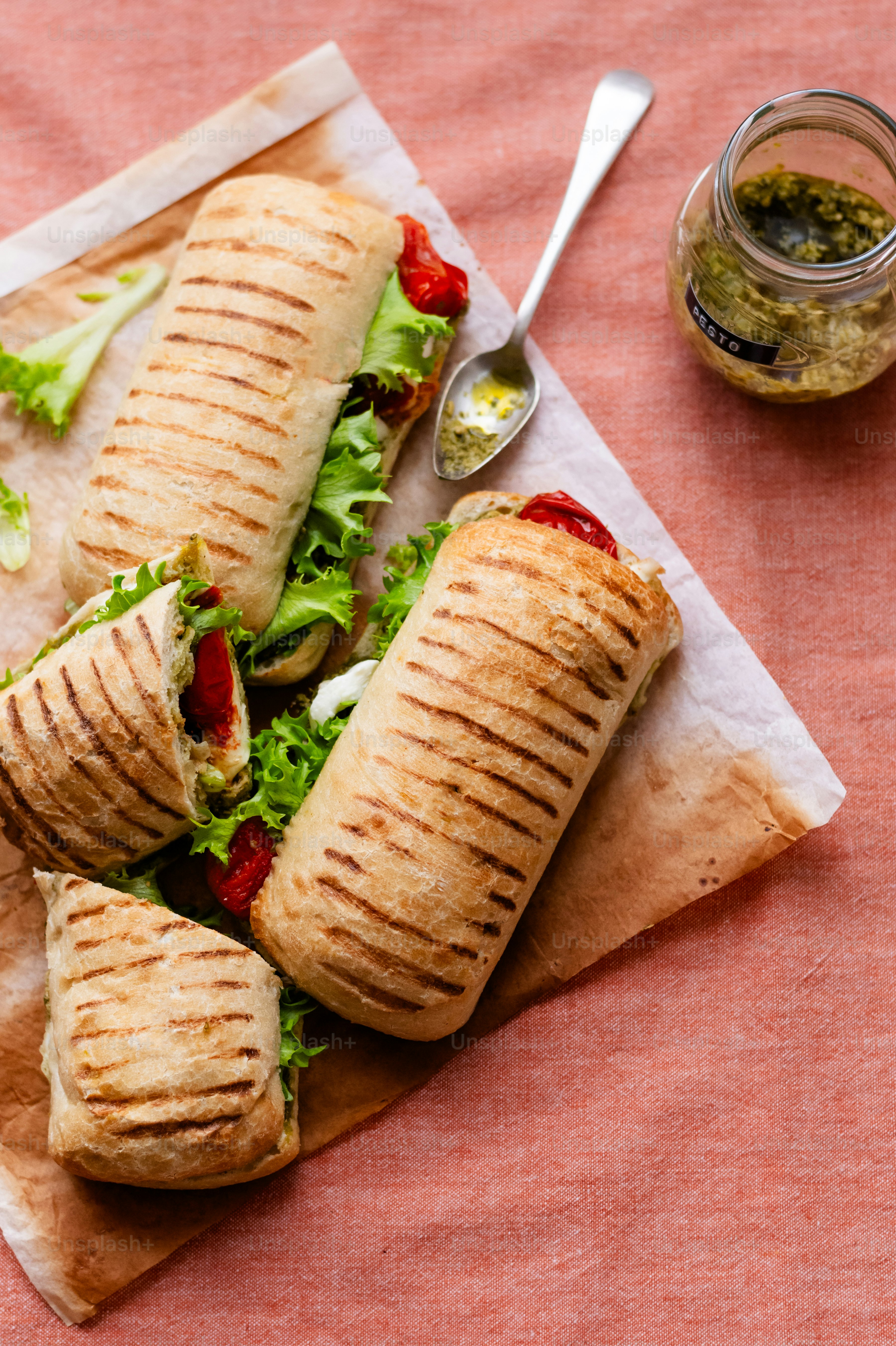 a couple of sandwiches sitting on top of a piece of paper