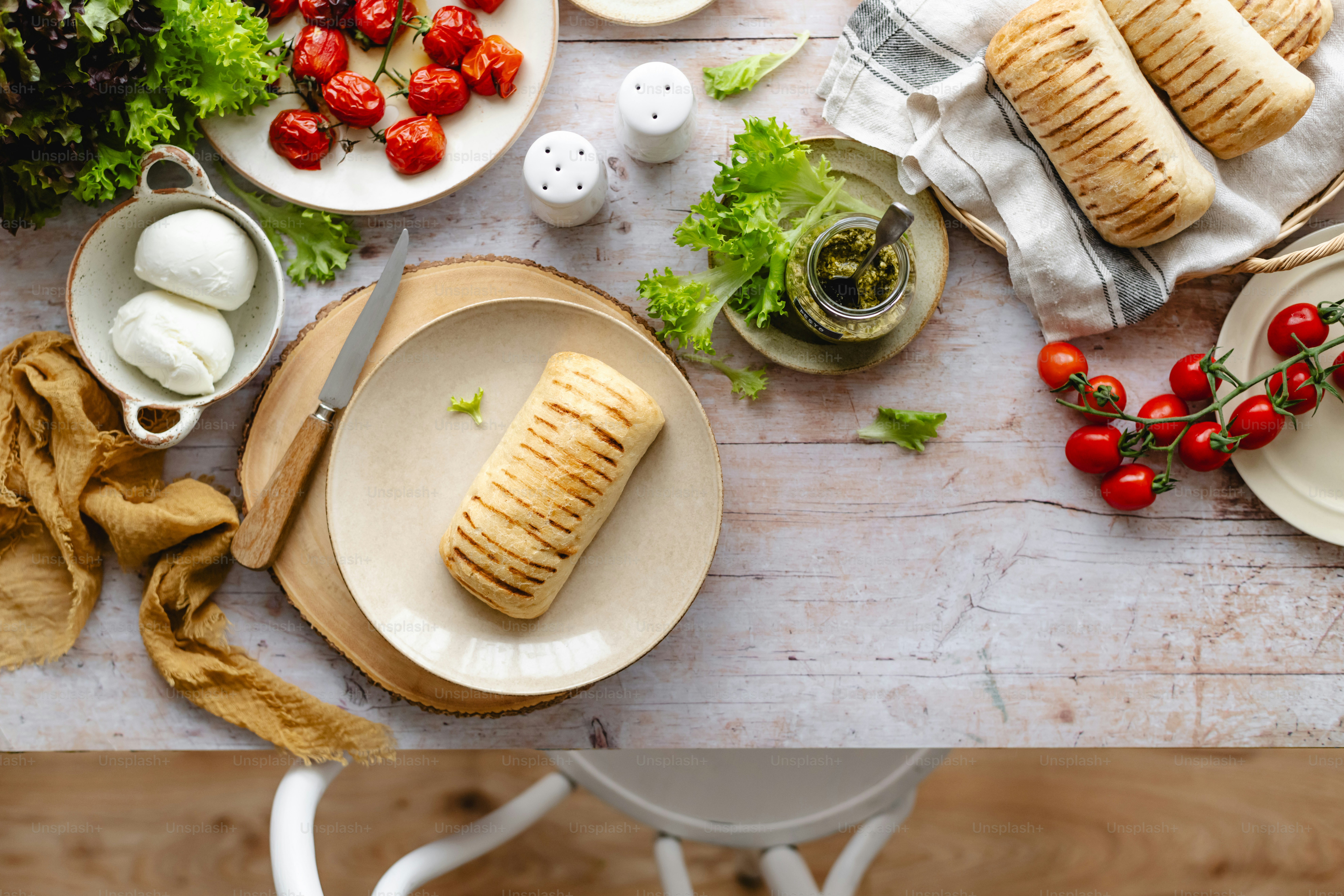 a table topped with plates and bowls of food