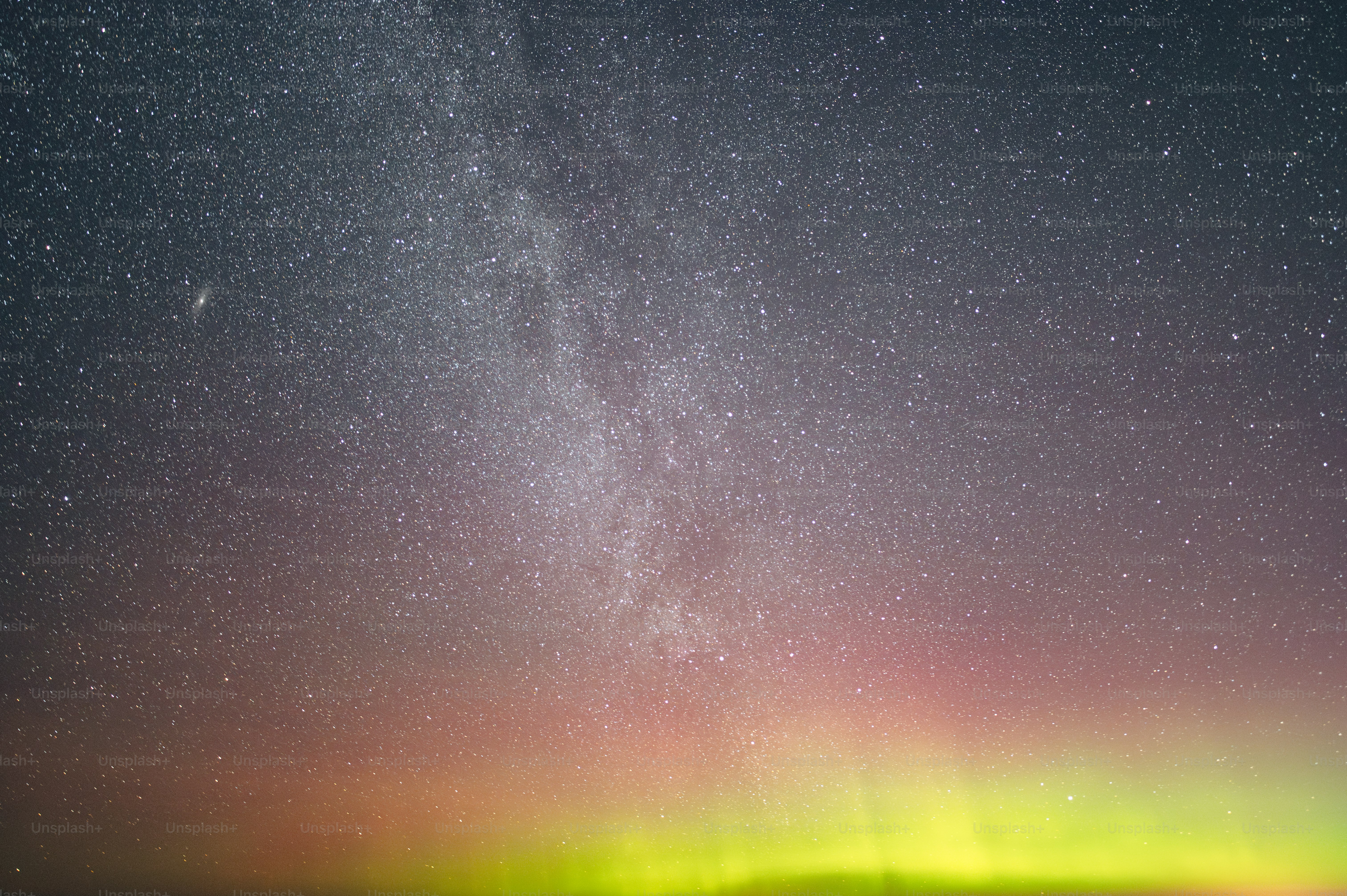 a bright green and red aurora over a body of water