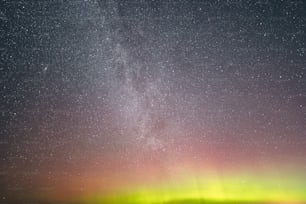 a bright green and red aurora over a body of water